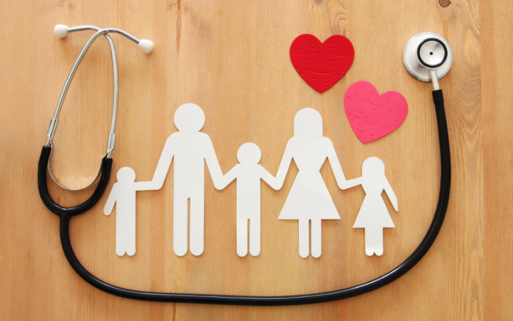 Image of a paper cut-out family holding hands with two read cut-out hearts above them, surrounded by a doctor's stethescope